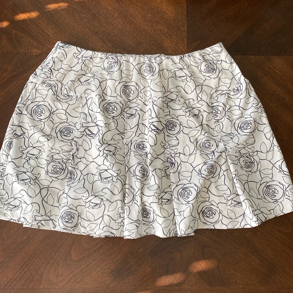 White and black print tennis skirt. 13 “ with shorties. Size: small.